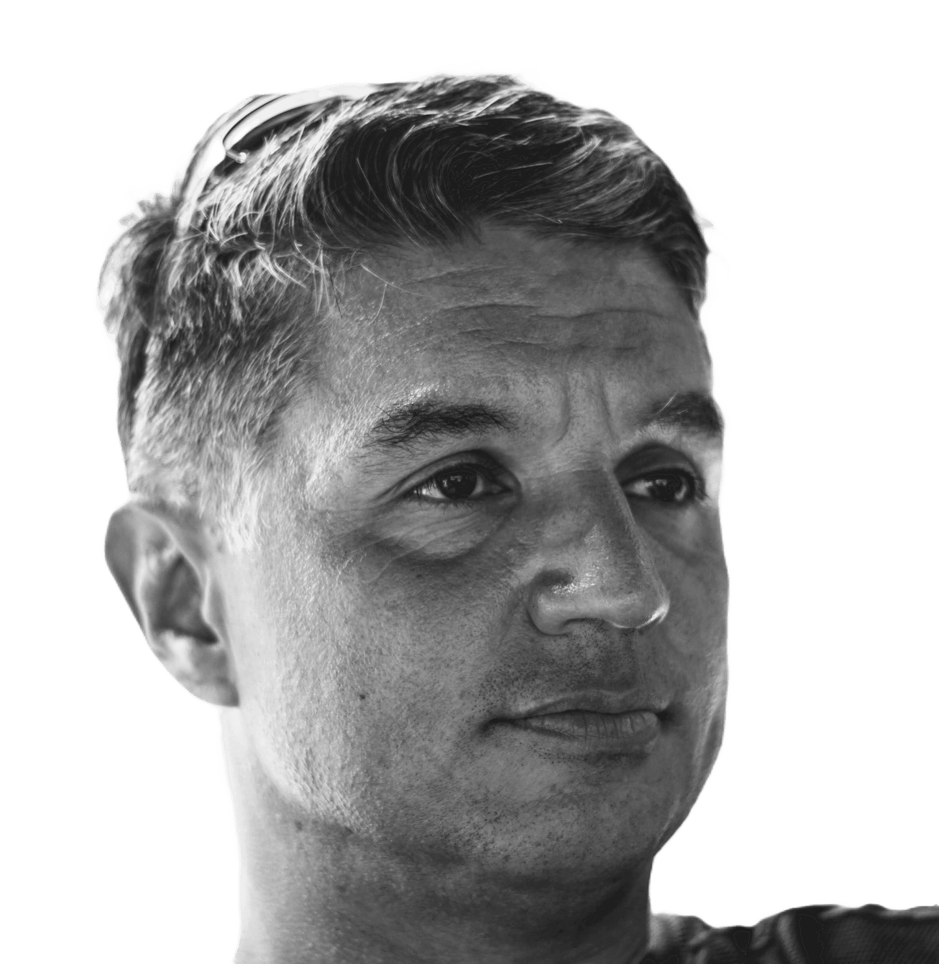Black and white image showing the back of a person's head with short hair on a black background.
